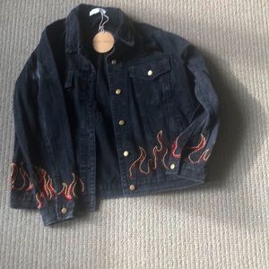 Black denim jeans jacket never worn. Gold and red studs. Open back.